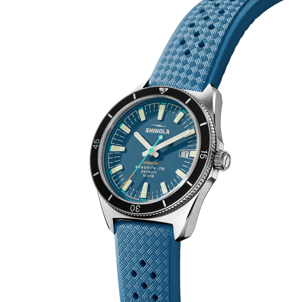 Blue dial watch with textured rubber strap.