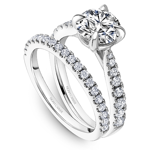 Platinum ring with round diamond side stones.