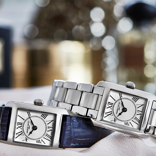 Stainless steel watches with Roman numeral dials.