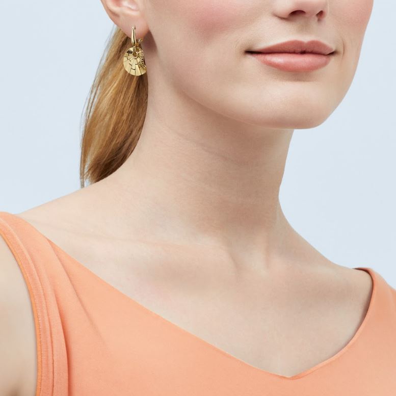 Gold earrings with textured disc design.