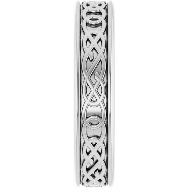 Carved white gold band with intricate pattern.