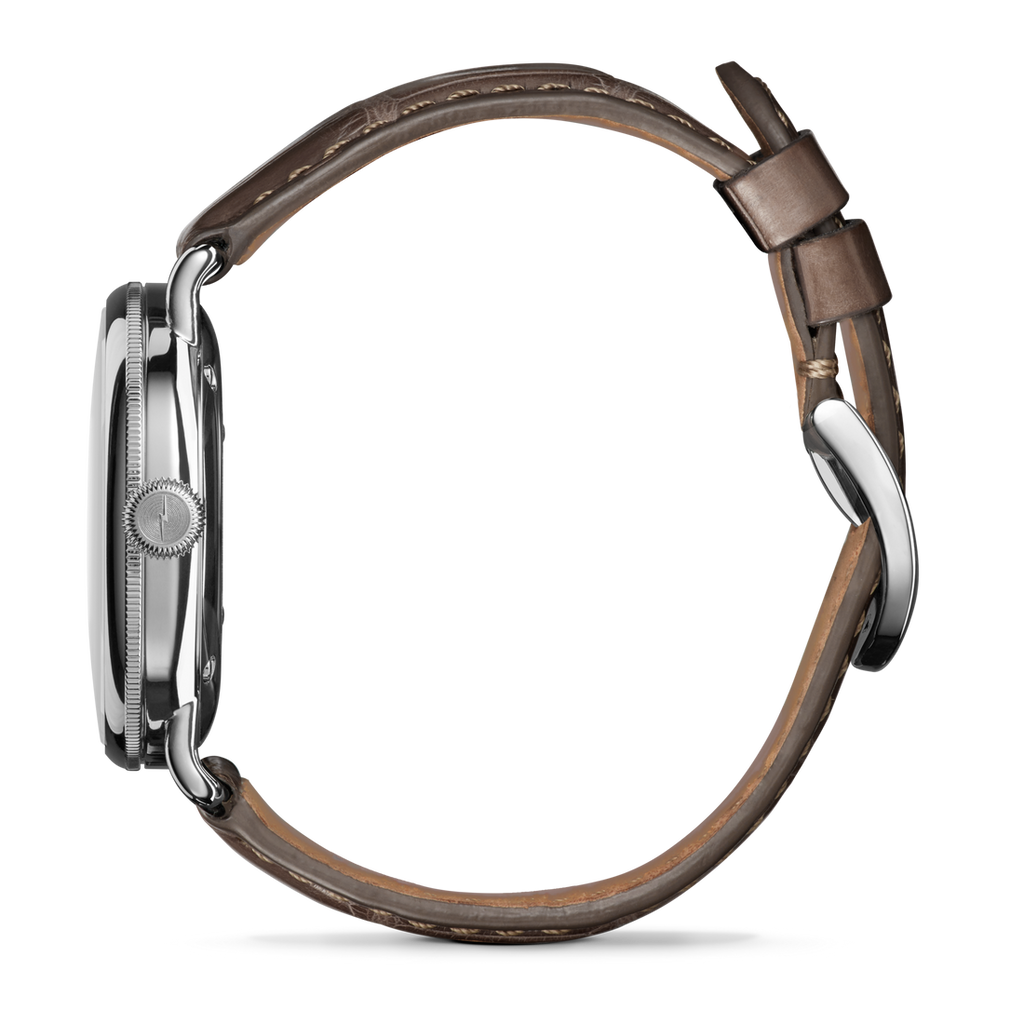 Stainless steel watch with brown alligator strap.