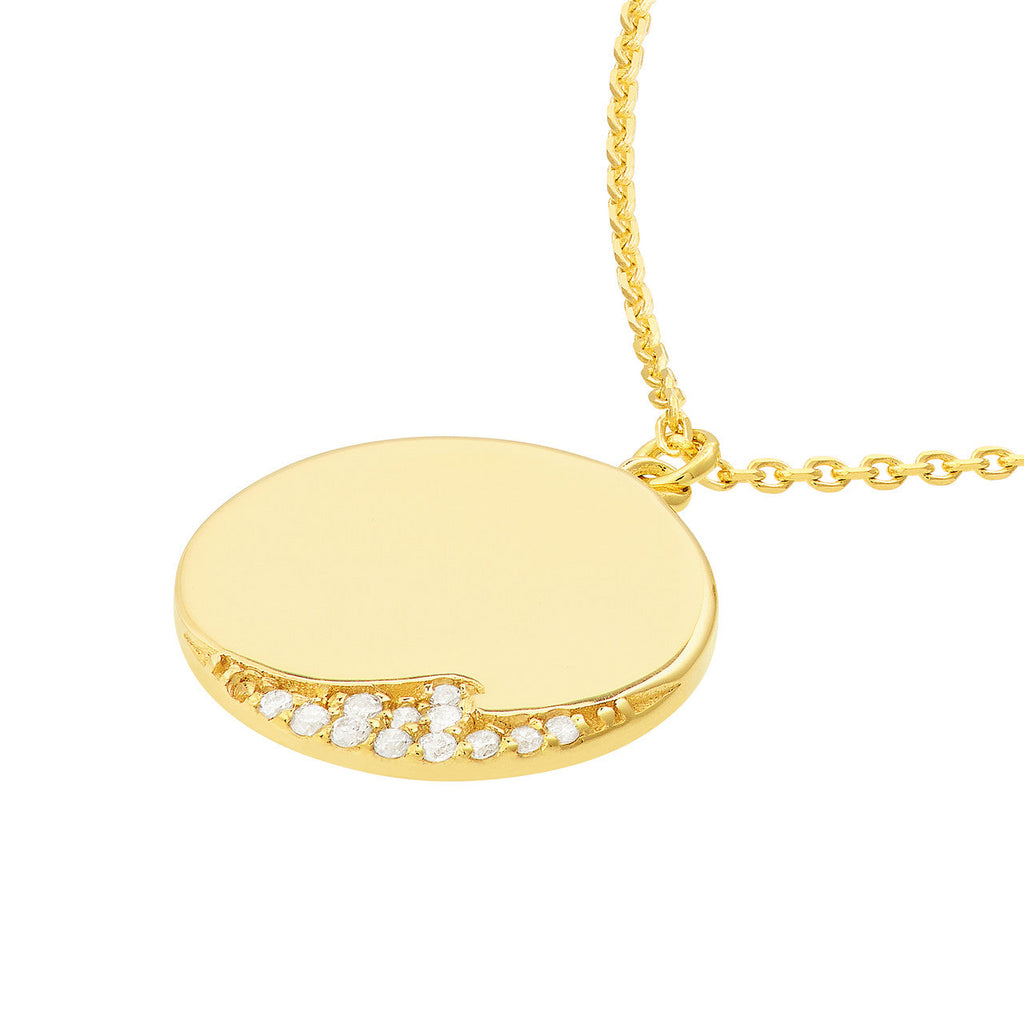 Round gold pendant with diamond accents.