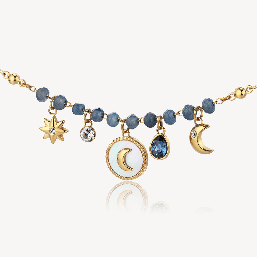 Gold necklace with blue gemstones and charms.