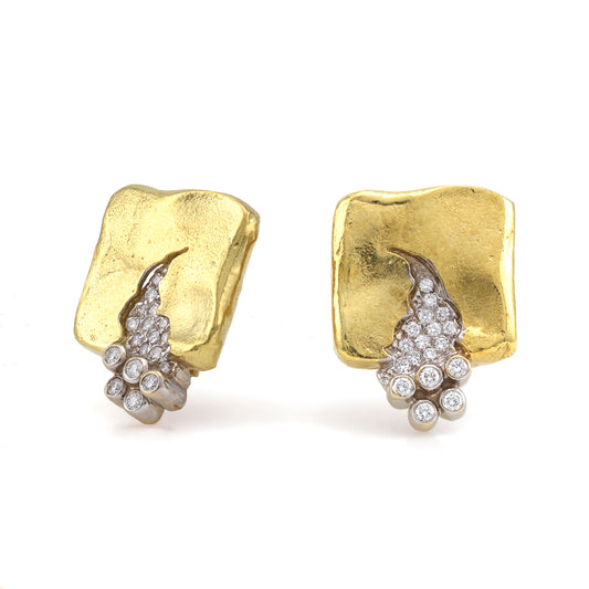 Gold square earrings with diamond clusters.