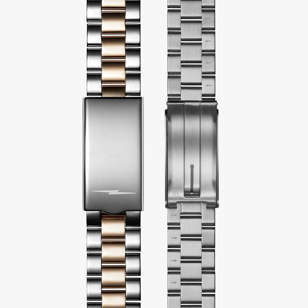 Stainless steel and gold watch clasp.