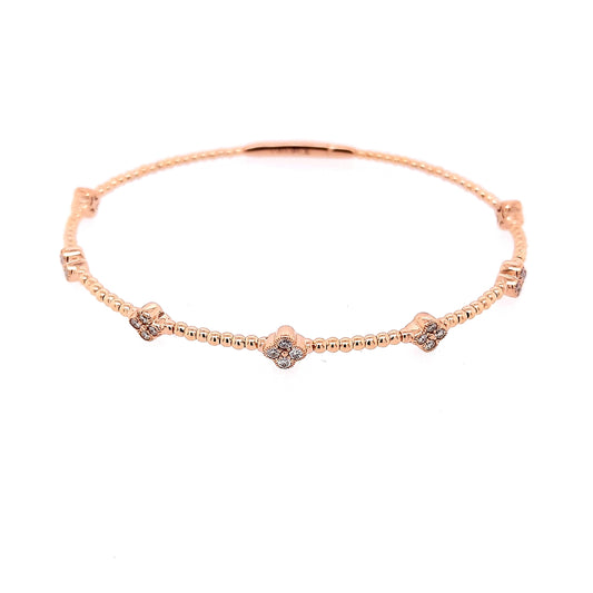 Rose gold bangle with round diamond clusters.