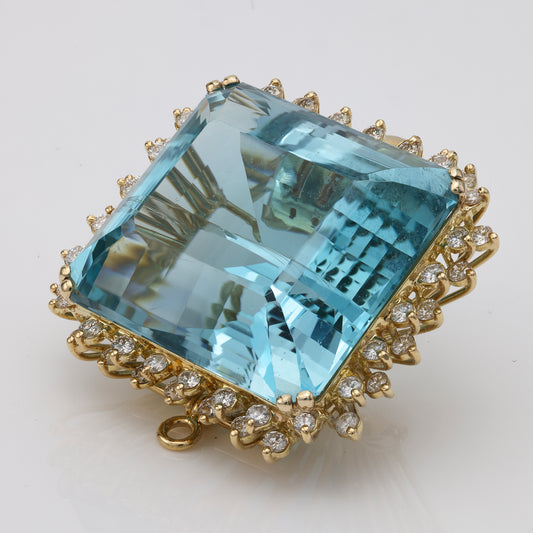 Cushion blue topaz, diamond halo, yellow gold.