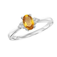 Oval citrine ring with diamonds, white gold band.