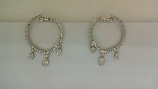 Round diamond earrings with dangling teardrop accents.
