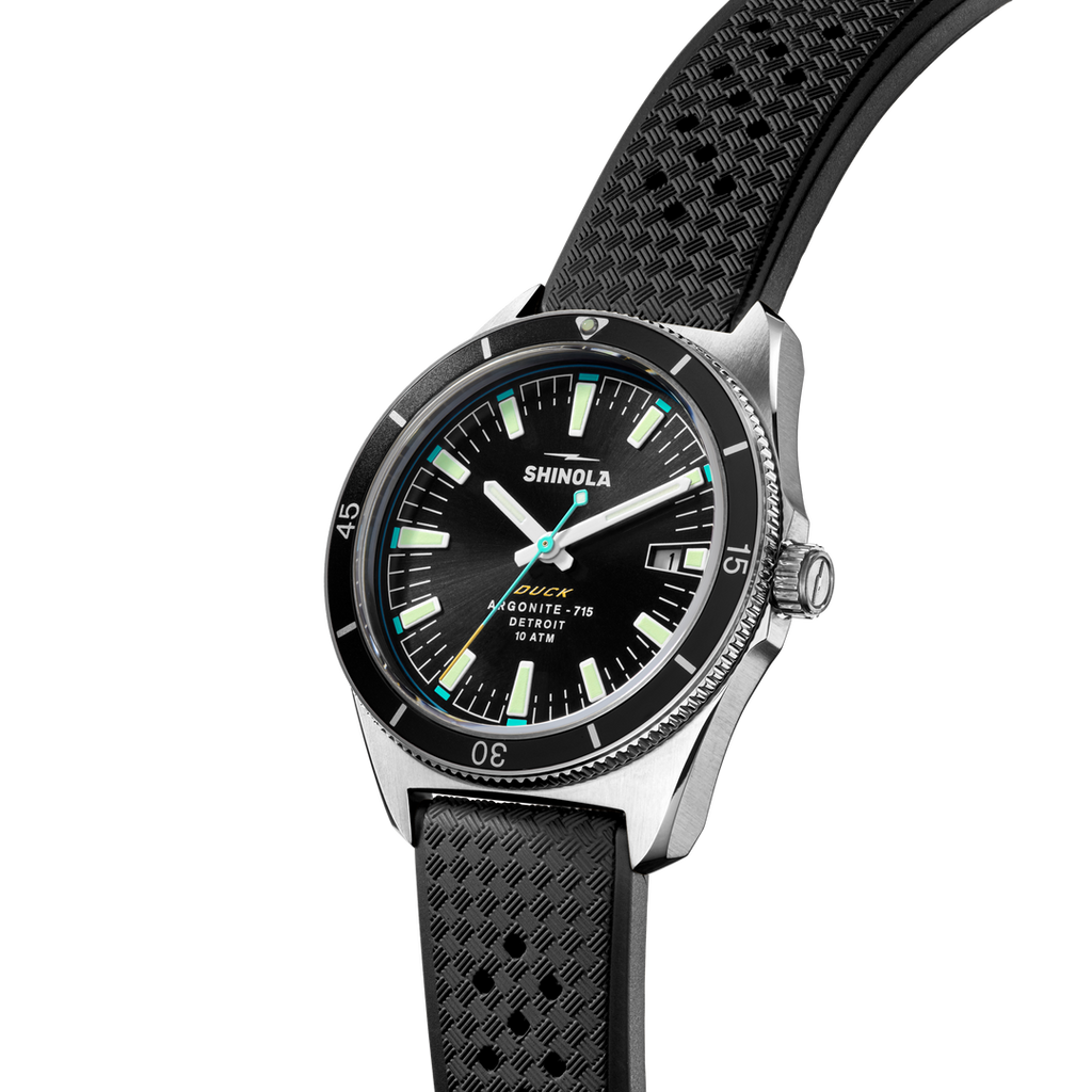 Black dial stainless steel watch with rubber band.