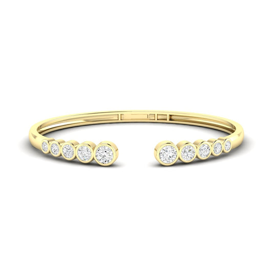 Yellow gold cuff bracelet with round diamonds.