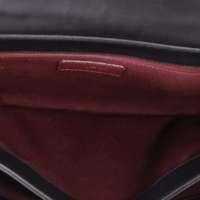 Burgundy interior of Chanel handbag.