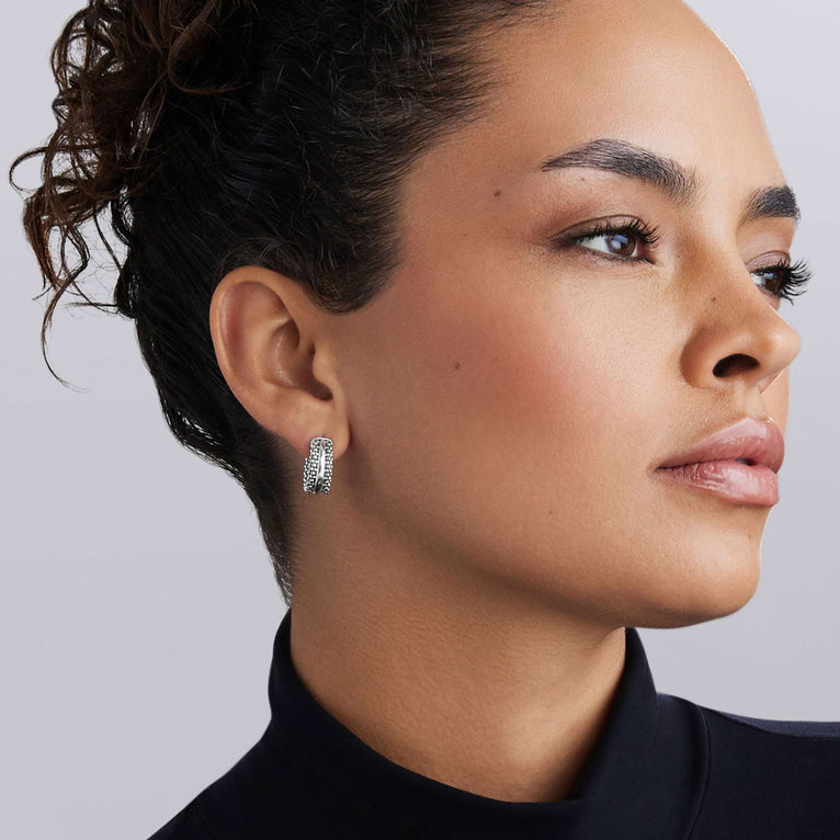 Sterling silver huggie earrings with caviar design.