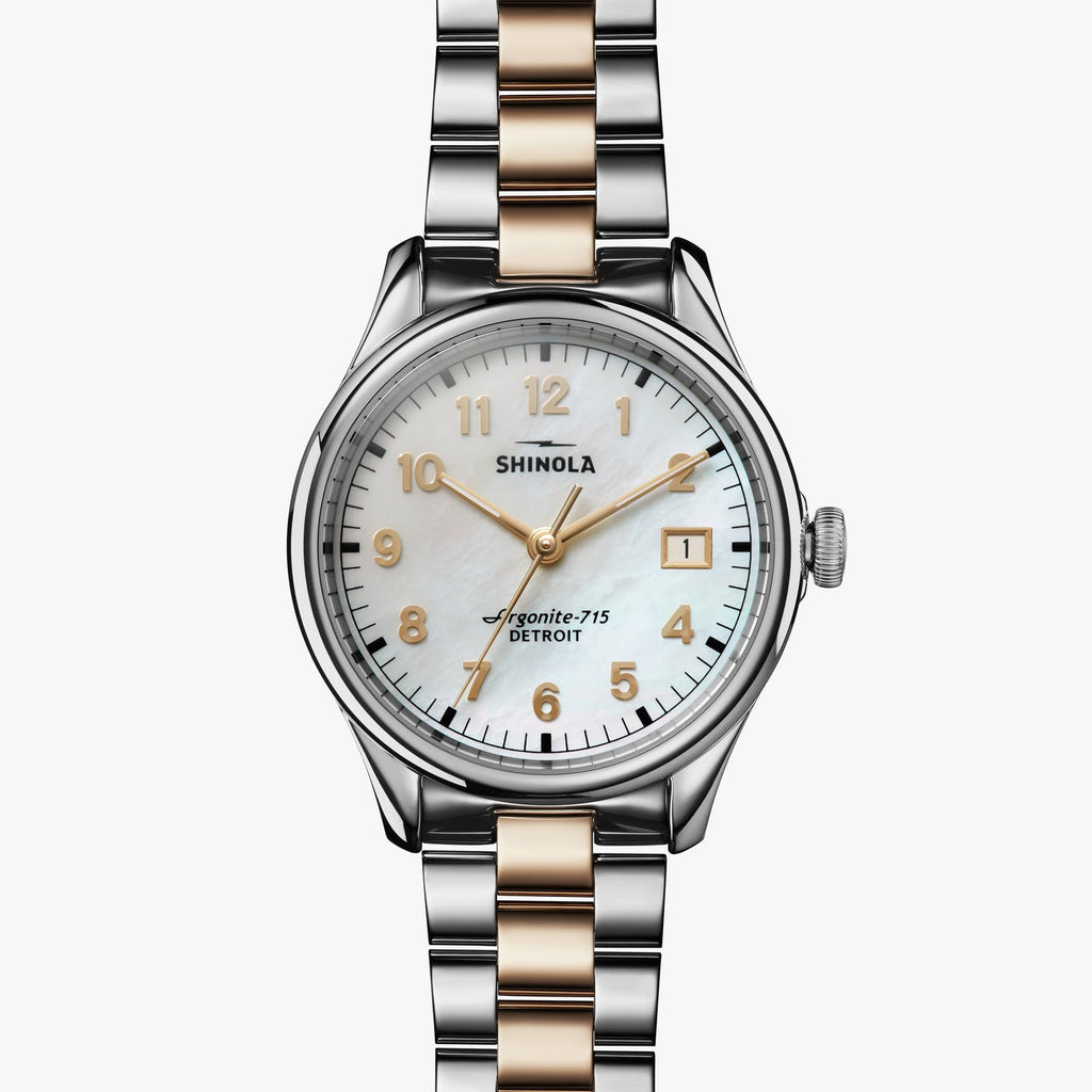 Stainless steel watch with mother of pearl dial.