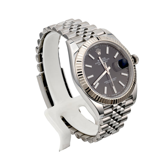 Silver dial, stainless steel, fluted bezel watch.