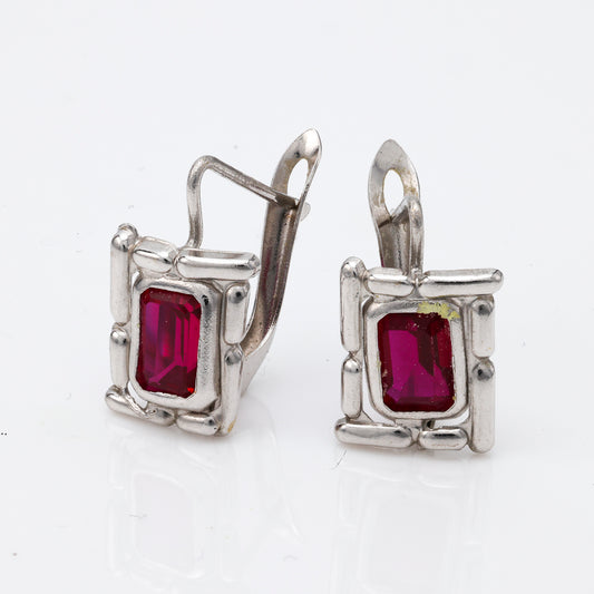 18K white gold earrings with emerald rubies.