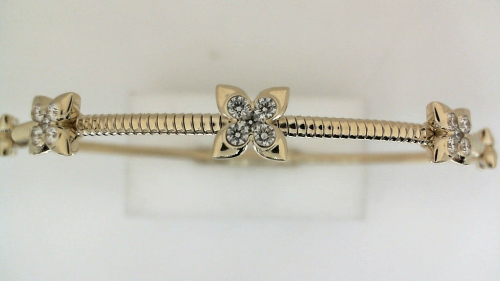 Yellow gold bracelet with diamond floral accents.