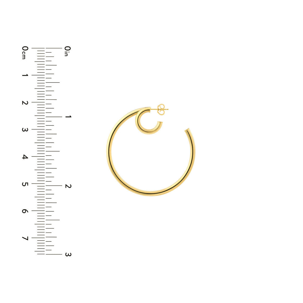 14K yellow gold hoop earrings with ruler.