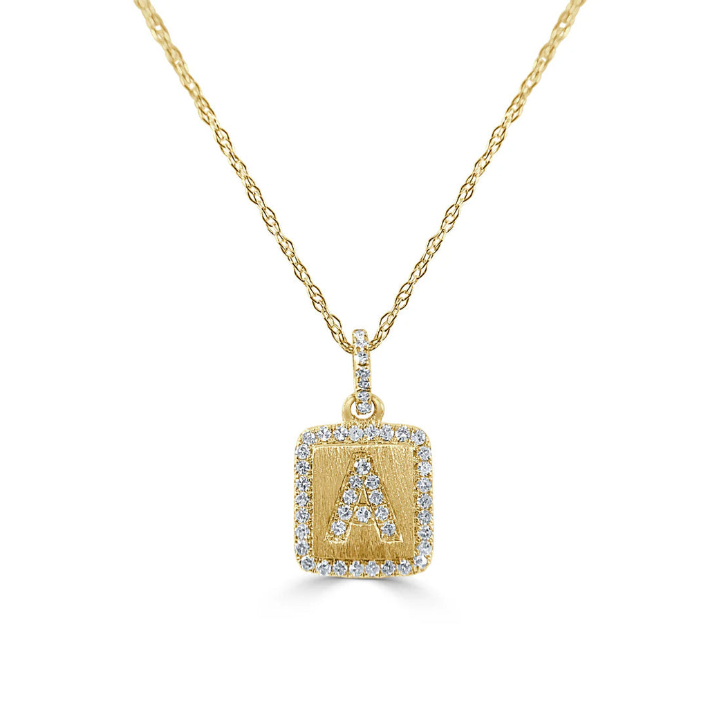 Gold necklace with diamond-accented square pendant.