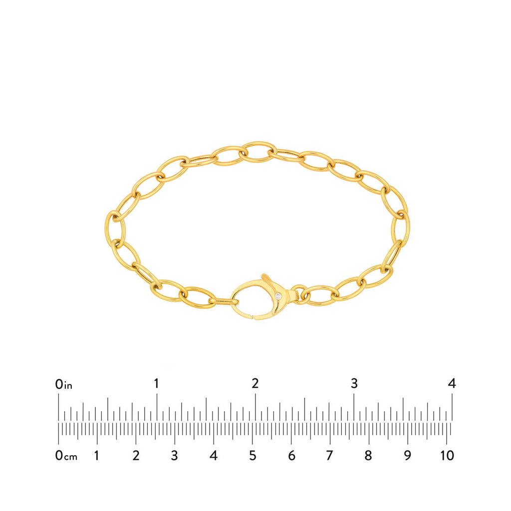Yellow gold oval link bracelet with diamond.