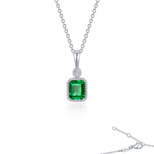 Simulated emerald pendant with diamond accent.