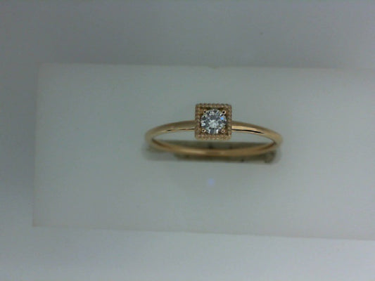 Rose gold ring with round diamond centerpiece.