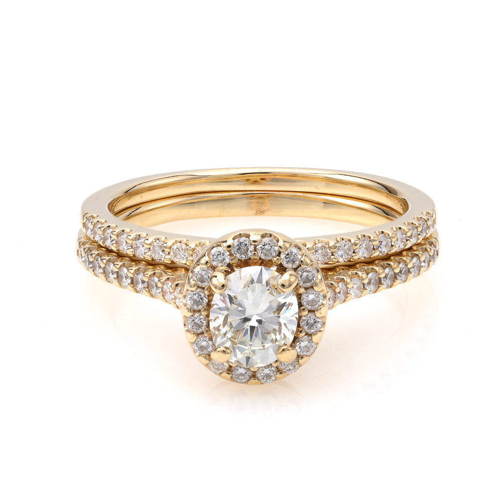 Halo oval diamond yellow gold ring.