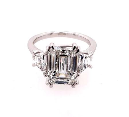 Emerald-cut diamond ring with trapezoid accents.