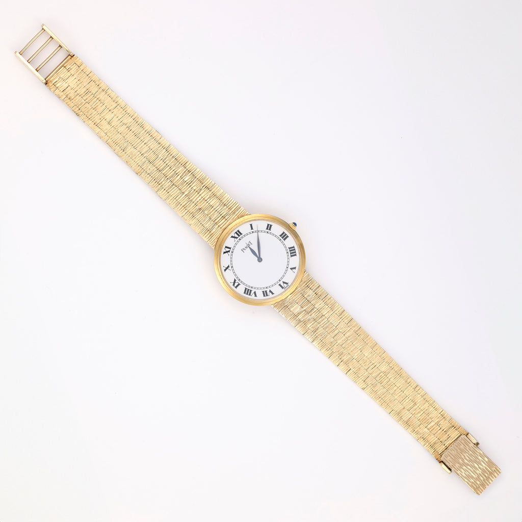 18K gold watch with white Roman numeral dial.