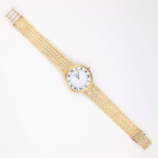 18K gold watch with white Roman numeral dial.