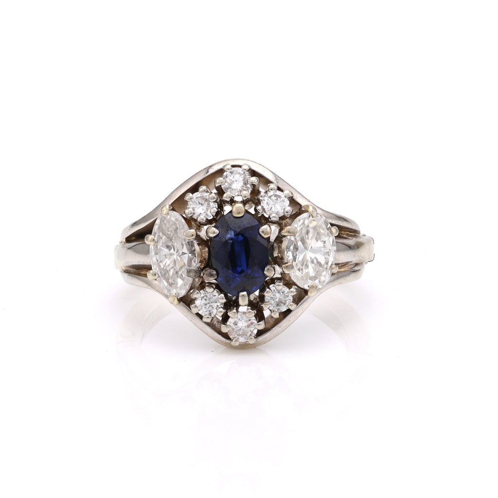 Oval sapphire ring with surrounding diamonds.