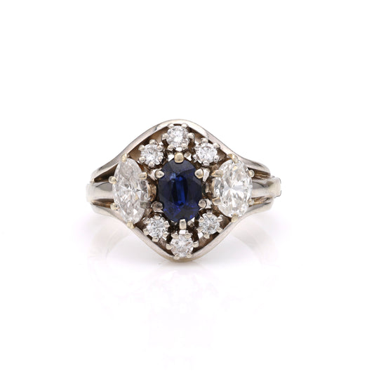 Oval sapphire ring with surrounding diamonds.