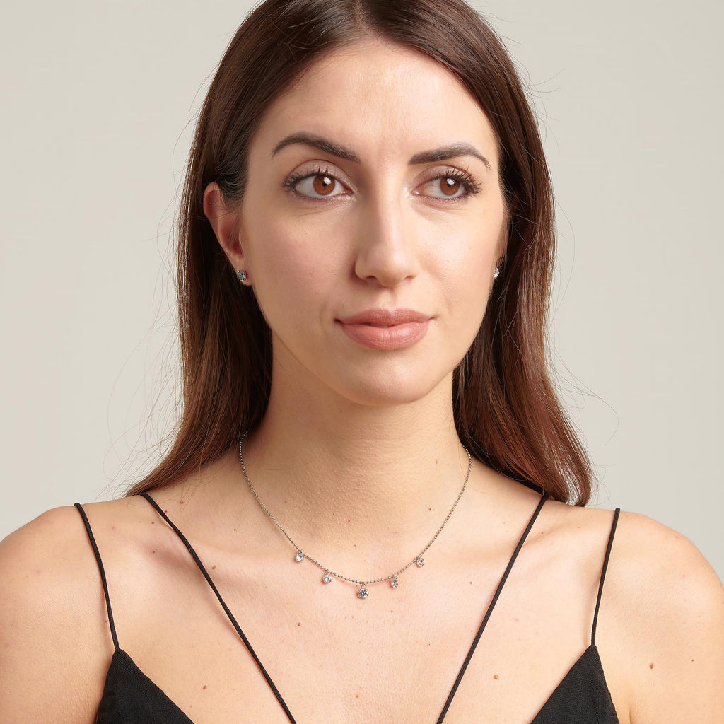 Simulated diamond pendant necklace on model.