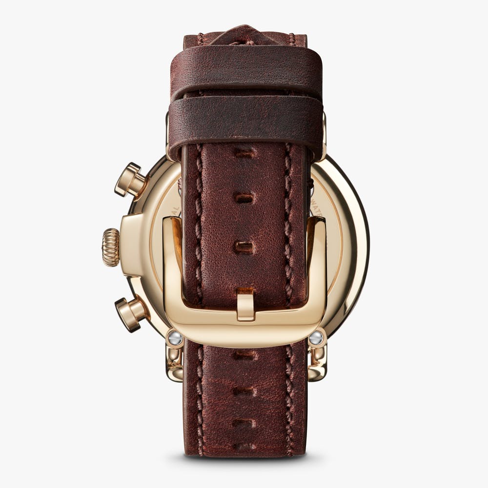 Brown leather watch strap, gold case back.