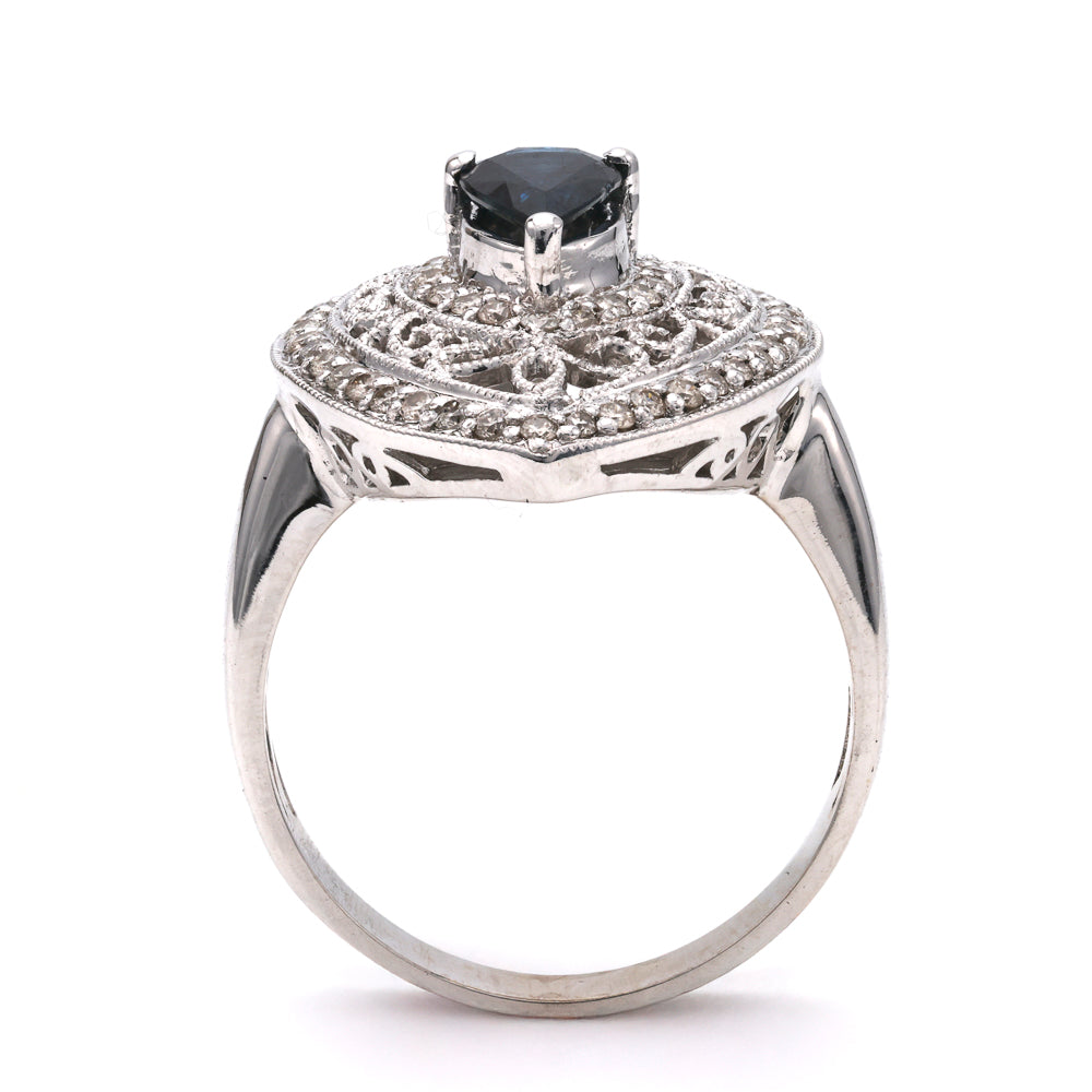 Pear sapphire ring with intricate diamond setting.