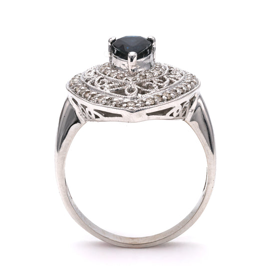 Pear sapphire ring with intricate diamond setting.