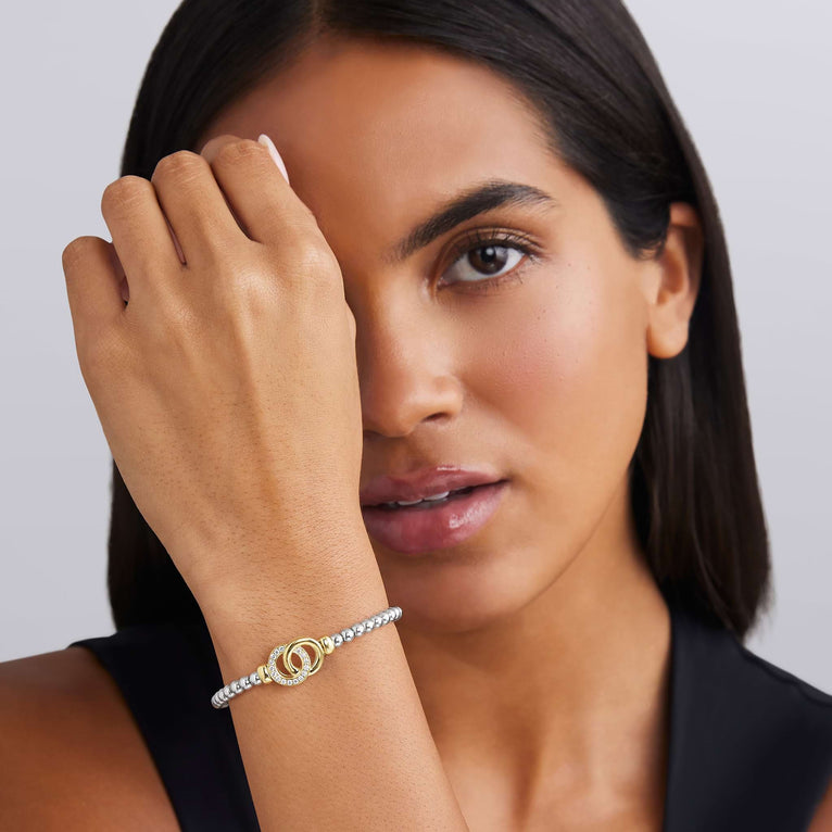 Sterling silver stretch bracelet with gold accents.
