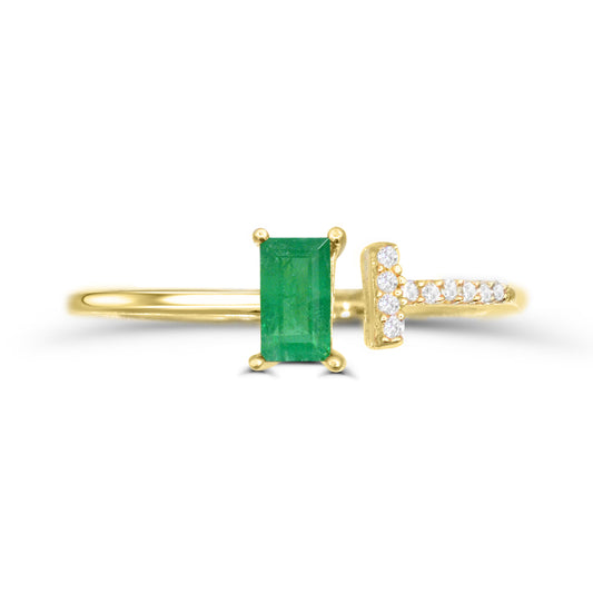 Emerald baguette ring with diamond accents.
