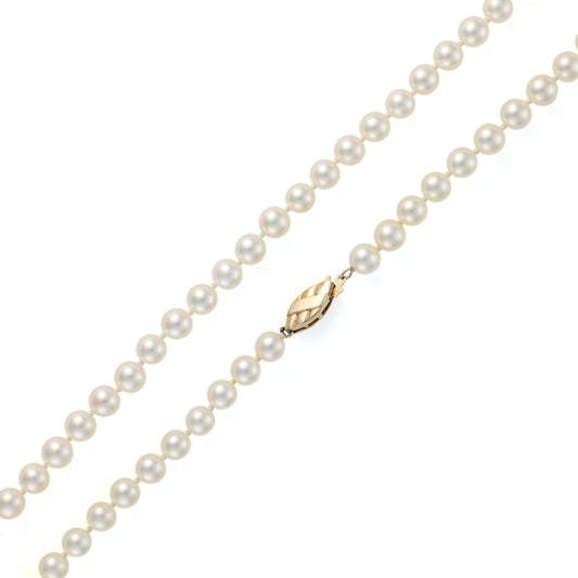 Cream Akoya pearl necklace with gold clasp.