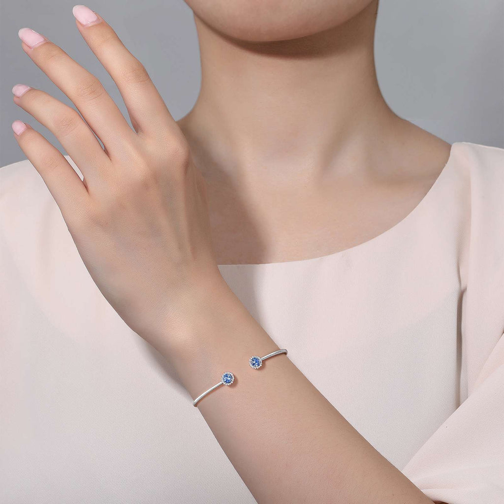 Platinum bangle with blue aquamarine stones.