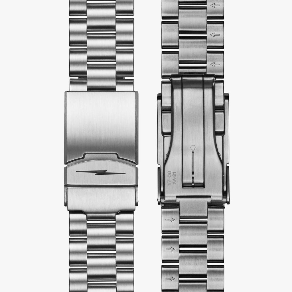 Stainless steel watch band with clasp detail.