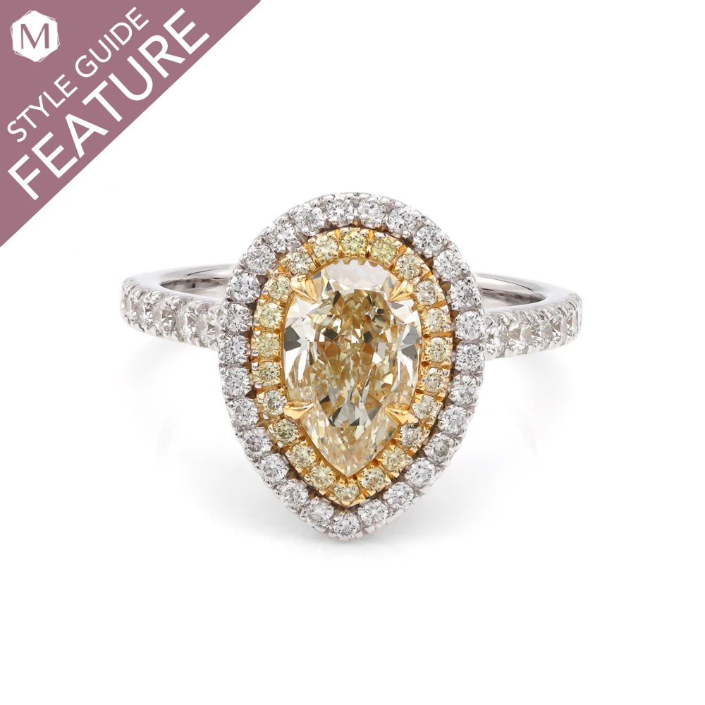 Pear-shaped diamond ring with yellow halo.