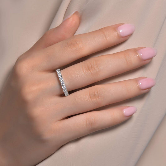 Simulated diamond band on hand, polished silver.