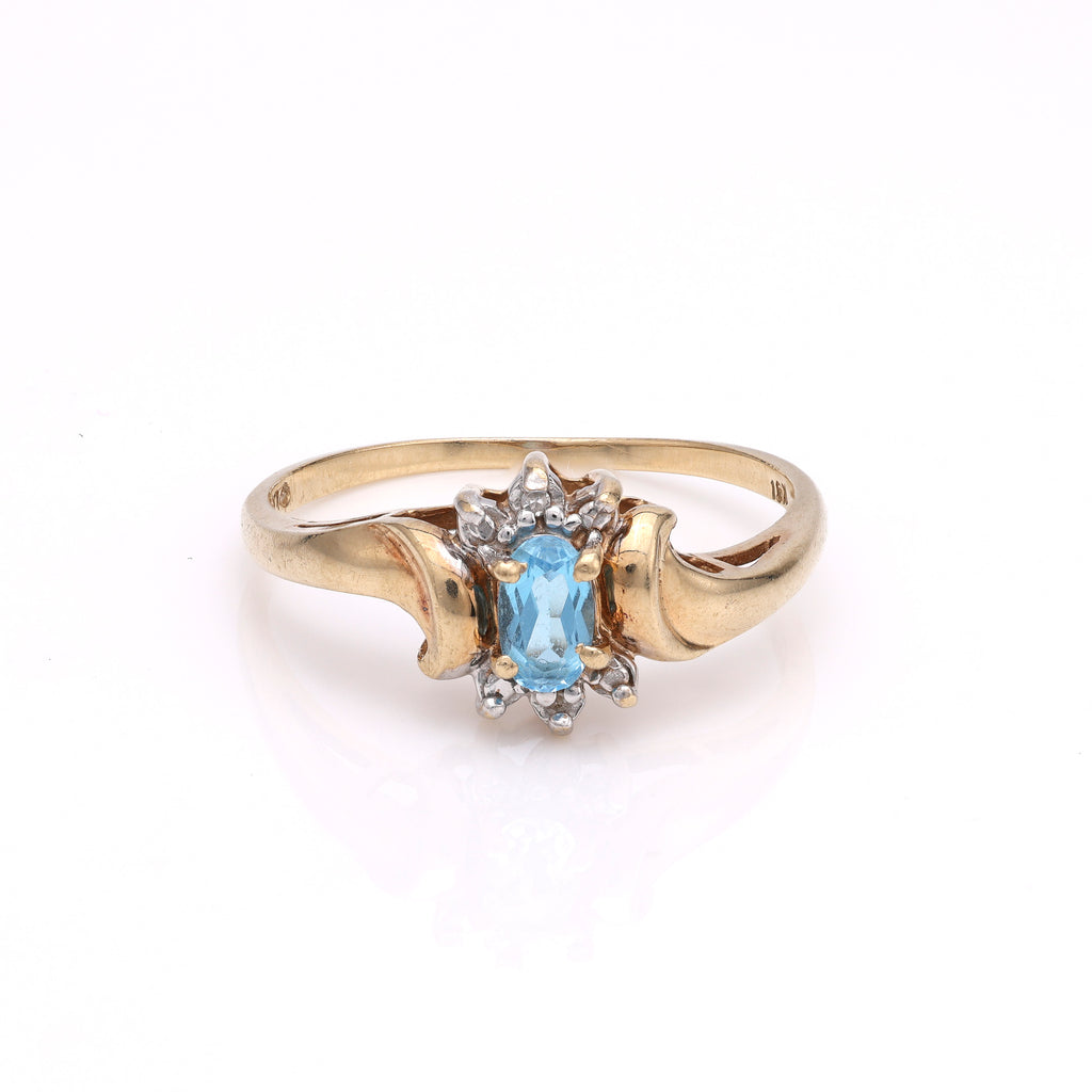 Oval blue topaz ring with diamonds.