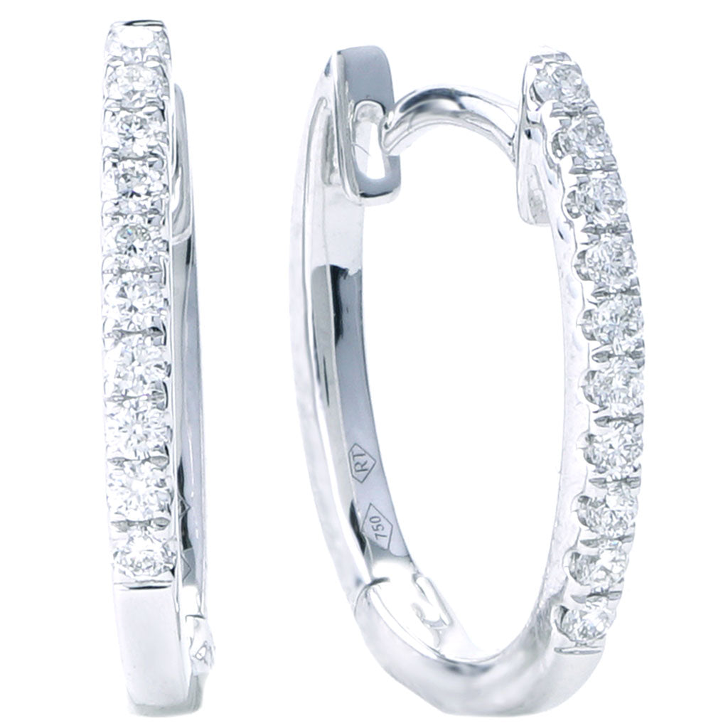 Medium white gold diamond hoop earrings.