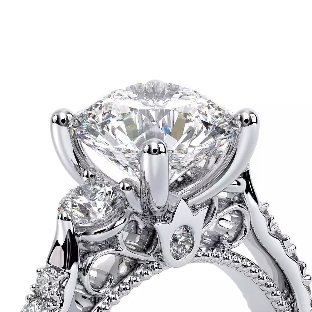Three-stone diamond ring with intricate setting.