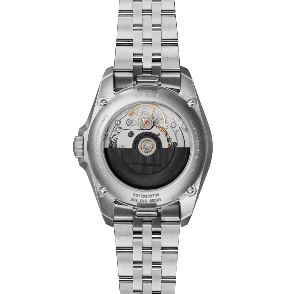 Stainless steel watch with visible automatic movement.