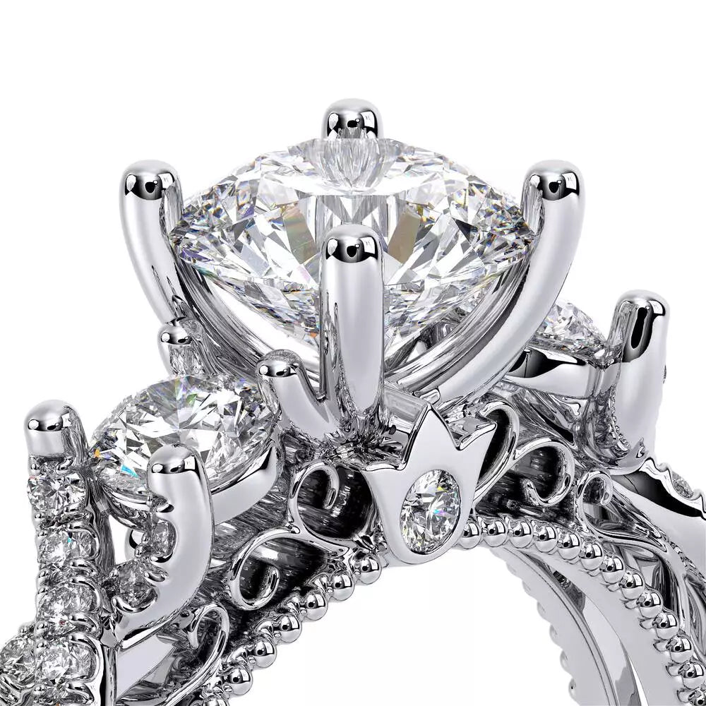 Three-stone diamond ring with intricate detailing.