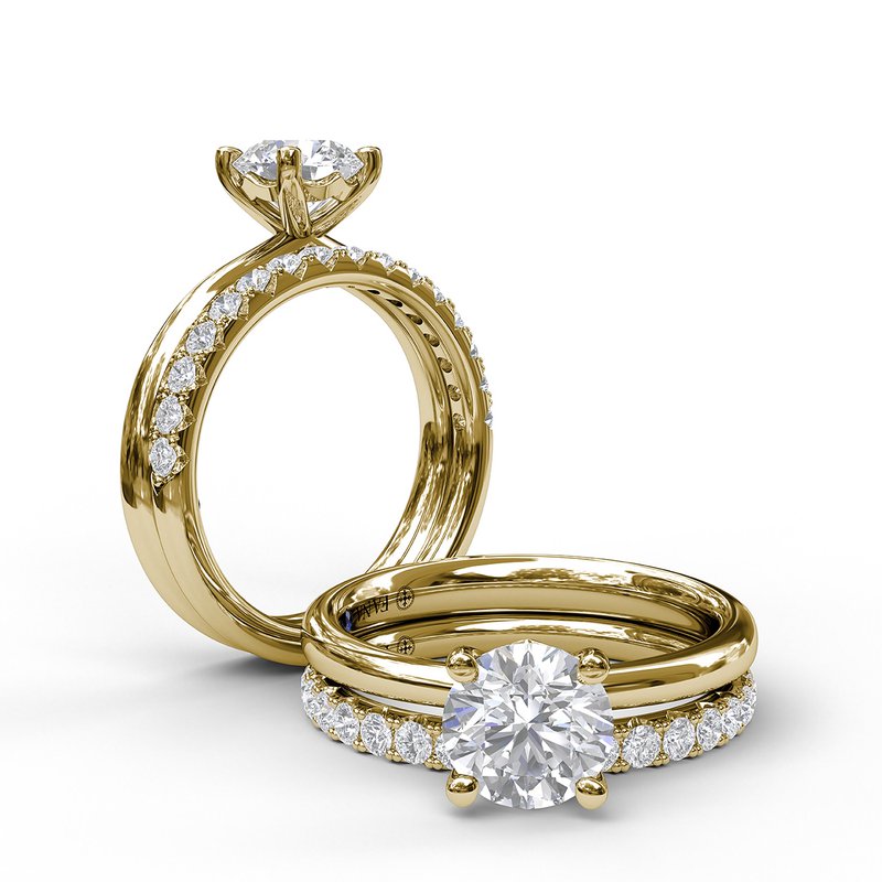 Yellow gold ring with round diamond centerpiece.